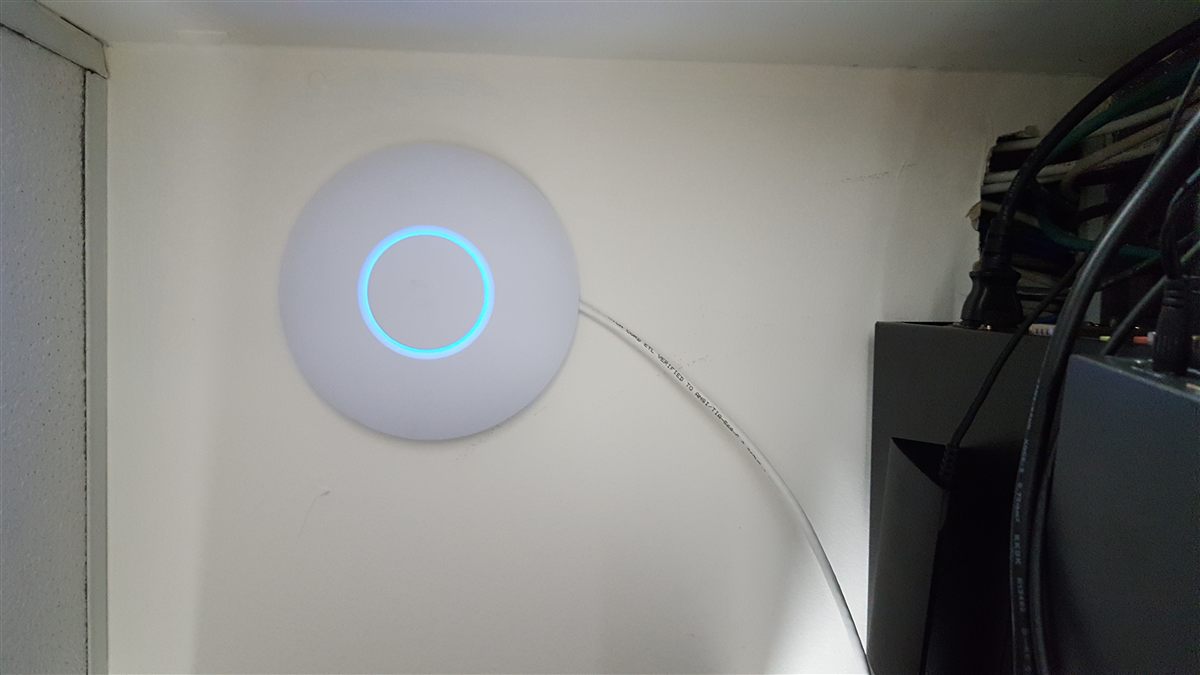 UniFi wireless access point installed on a commercial ceiling