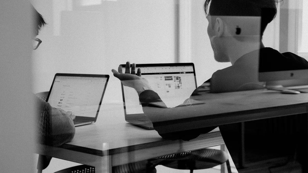 Colleagues using laptops for office productivity software